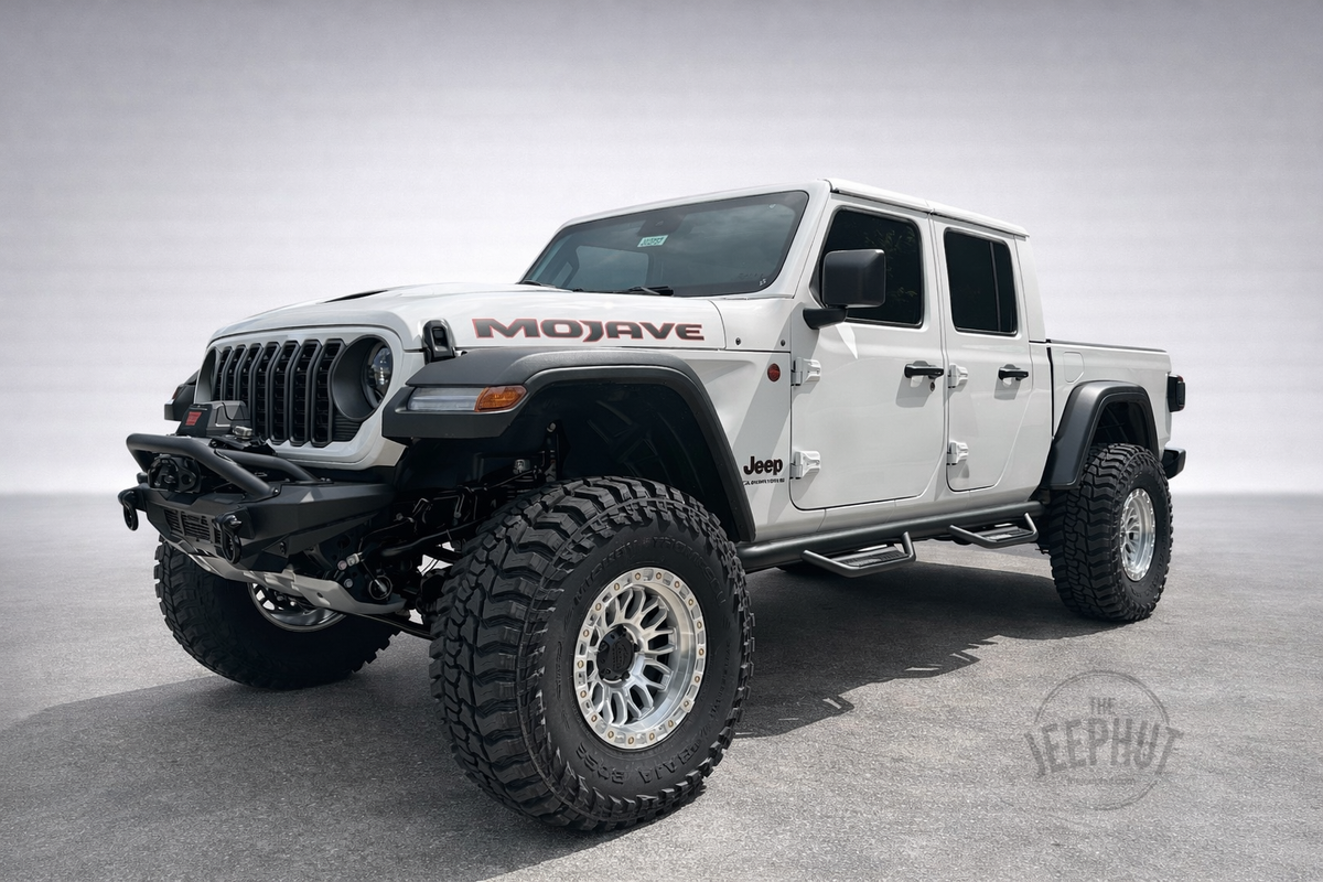 White 2025 Jeep Gladiator Mojave Mountain Mojave build with lifted suspension, large mud-terrain tires, machined wheels, DV8 front bumper, WARN winch and N-Fab side steps